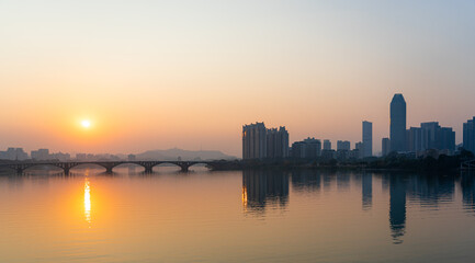 Fototapeta premium Sunset scenery of Jiangbei Business CBD and Dongjiang Bridge in Huizhou, China