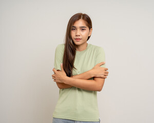 Young asian woman feel cold. Frozen Winter season. Hug herself warming up temperature. Female...
