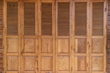 Wooden shuttered doors design rustic home exterior photography natural light close-up view architectural concept