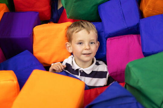 Boy playing in colorful foam pit