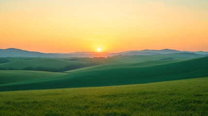 Obraz premium Serene sunrise over rolling green hills.