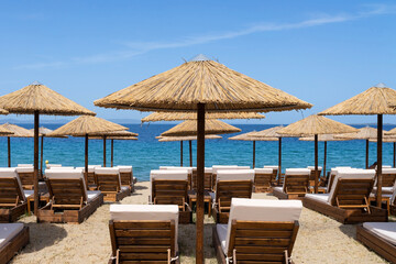 Sunbeds and sun umbrellas on the Greek beaches