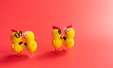 red gradient background with toy chickens in situations