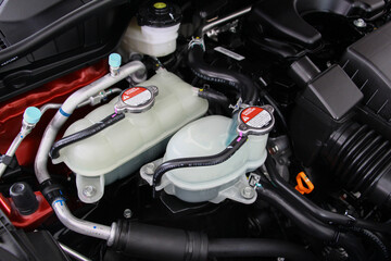 Car radiator cap in the engine room. Radiator cap with warning label in a car engine. car maintenance and repair concept. components of car concept.