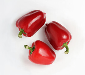 Three red peppers on a white background. Group. Top view 