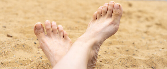 women's feet on the sand