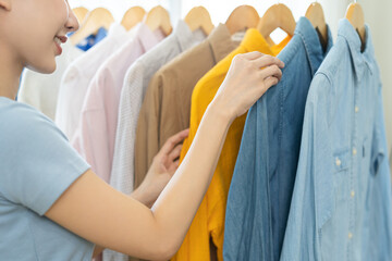 man and woman holding clothes