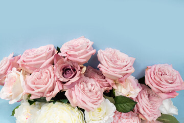 Blooming pink rose flowers bouquet on blue background for Mother's Day