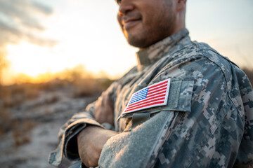 Us Army veteran honors Veterans Day. Man soldier adjusts the US military patch before duty. A US...