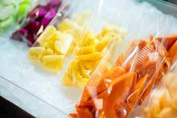 Various fruits on ice shelf at street food market