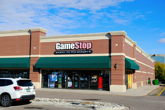 Gamestop store exterior with entrance sign with brand name logo.