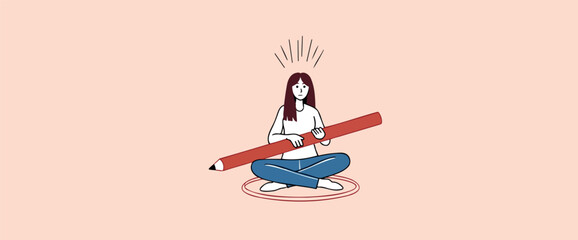 young woman sitting -legged holding a large red pencil suggesting creativity and planning.