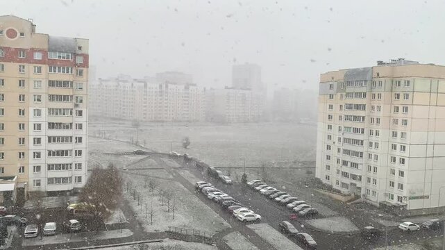 View of a snow-covered city. The beginning of a heavy snowfall.