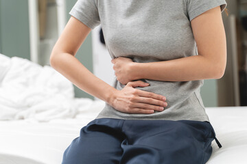 Menstruation symptom concept, Close-up woman touching her belly and feeling stomach pain from cycle...