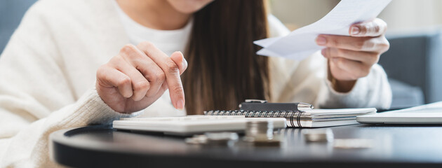 Close-up person using a calculator to  plan monthly expense and account