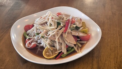 Spicy papaya salad is a spicy dish in Thailand.