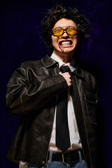 Stylish asian man showcasing bold fashion choices for spring in studio environment