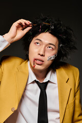 Stylish asian man showcases unique fashion in a studio setting perfect for spring vibes