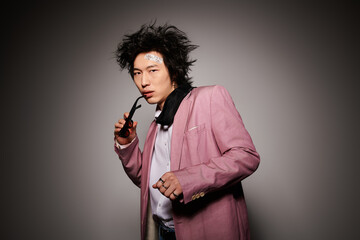 Stylish spring fashion showcase featuring a confident Asian man in a studio environment