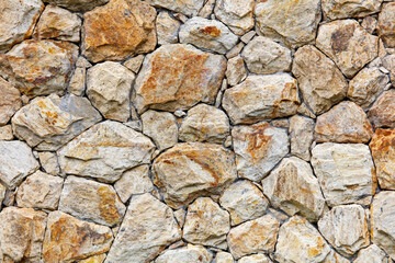 A wall made of large rocks with a rough texture