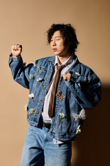 Stylish asian man showcases vibrant spring fashion in studio setting with floral accents