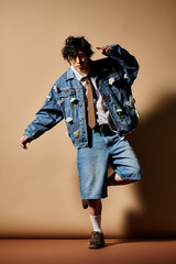 Trendy spring fashion: an Asian man in stylish attire shows creativity in a studio