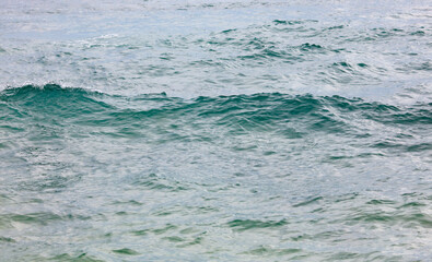 The ocean is calm and the water is a beautiful shade of blue