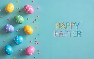 Colorful Easter Eggs Flat Lay on Blue Background with Copy Space