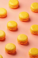 Obraz premium Pattern of vibrant yellow macaroon cookies arranged in a geometric layout on a soft pink background, sweets, pattern