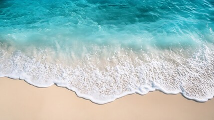 Turquoise ocean waves gently lapping on a sandy beach.