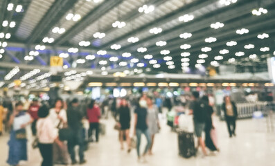 Defocus Blurry passengers people of crowd anonymous walking at the airport. scene of airport with passengers activity. Terminal Departure Check-in at airport. Travel International concept.