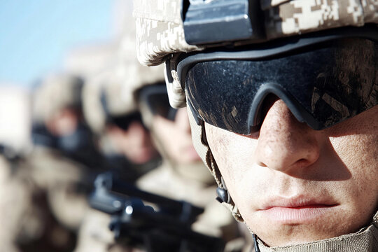 Soldiers equipped with night vision goggles prepare for a covert mission in a desert environment at night