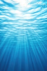 Bright sun rays penetrate tranquil blue water, creating mesmeriz