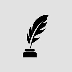 A black quill pen standing in an inkwell on gray background