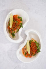 Delicious canapes with black and red caviar on wooden table
