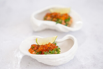 Delicious canapes with black and red caviar on wooden table