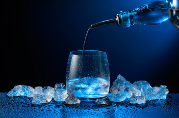 Vodka pours from bottle to glass.