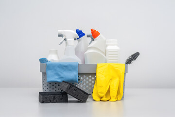 Cleaning supplies and equipment in a grey bucket