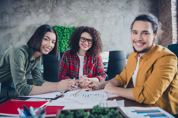 Young multicultural team of coworkers collaborating on a project in a modern office setting
