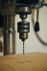 Close-up of lathe drilling wooden plank automatically