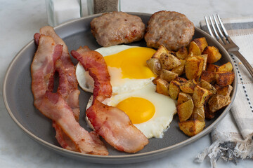  fried eggs  with bacon and sausage patties