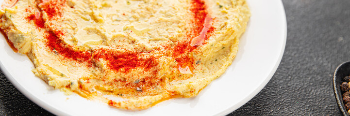 Hummus chickpea dip spices tasty appetizer vegetable dish fresh gourmet vegetarian and vegan food background on the table rustic food top view 