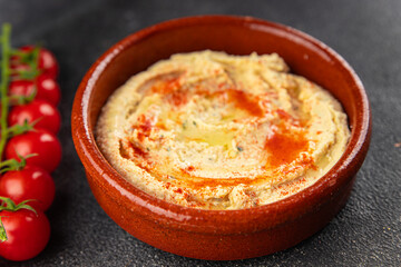 Hummus chickpea dip spices tasty appetizer vegetable dish fresh gourmet vegetarian and vegan food background on the table rustic food top view 