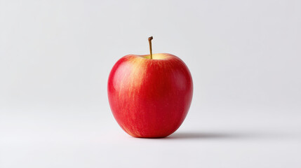 vibrant red apple with smooth surface sits on white background, showcasing its fresh and appealing look