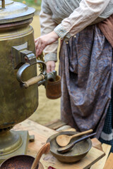 A woman is pouring something into a pot