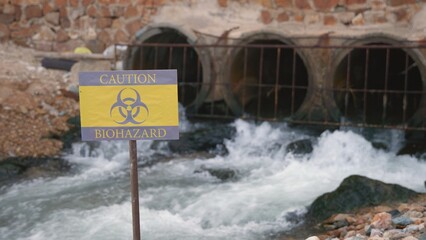 Close up of warning sign lable biohazard caution of collects sample of waste water from industrial,...