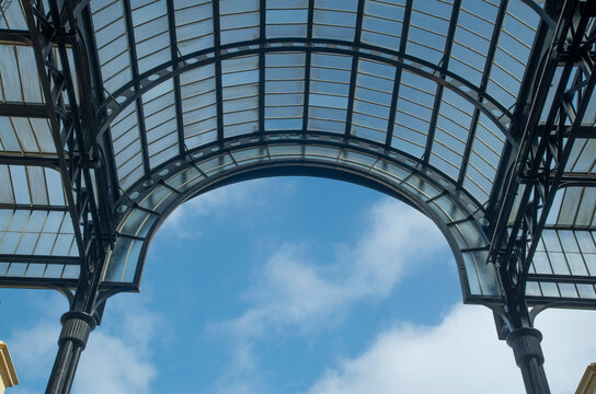 Detail of Steel framed Glass gallery and blue cloudy sky