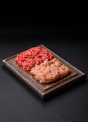 Beef and chicken minced meat, ground of two types fresh raw with salt and spices