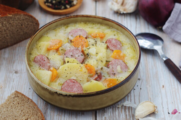 A bowl with traditional German potato soup with sausages