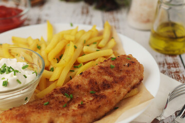 Fish and chips served on the plate, traditional dish of Great Britain	